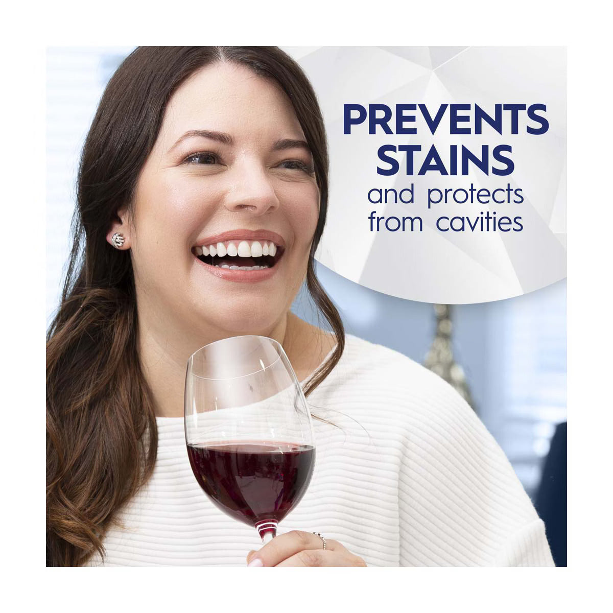 Woman holding a glass of red wine with dental care product text overlay