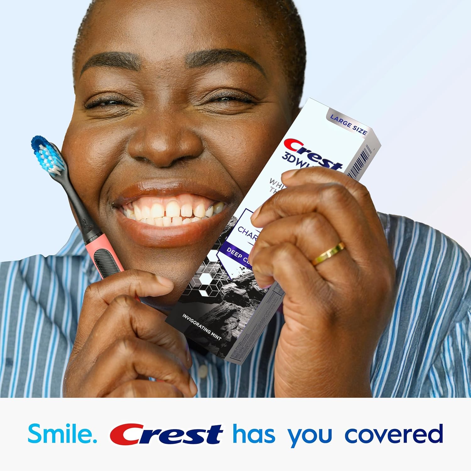 Person holding a toothbrush and Crest toothpaste with 'Smile. Crest has you covered' text.