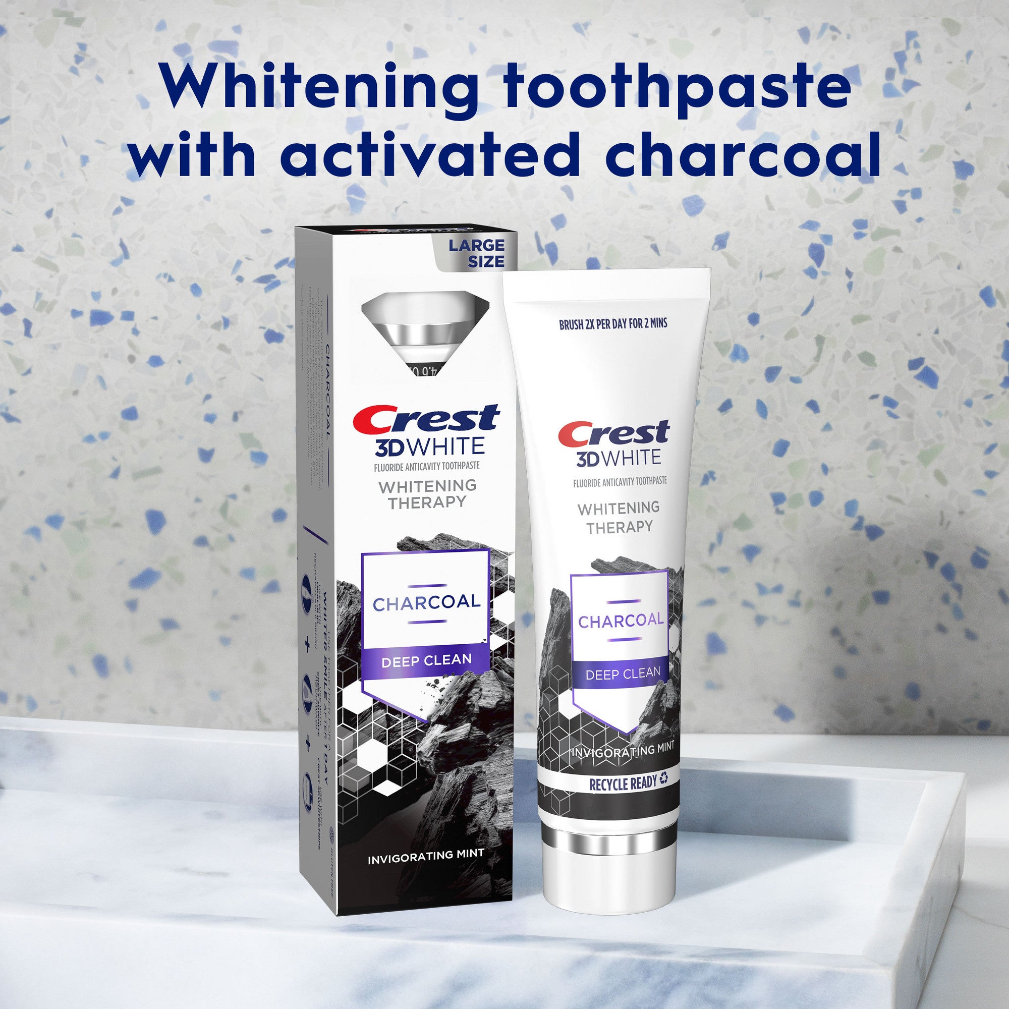 Crest 3D White Whitening Toothpaste with activated charcoal packaging on a bathroom counter.