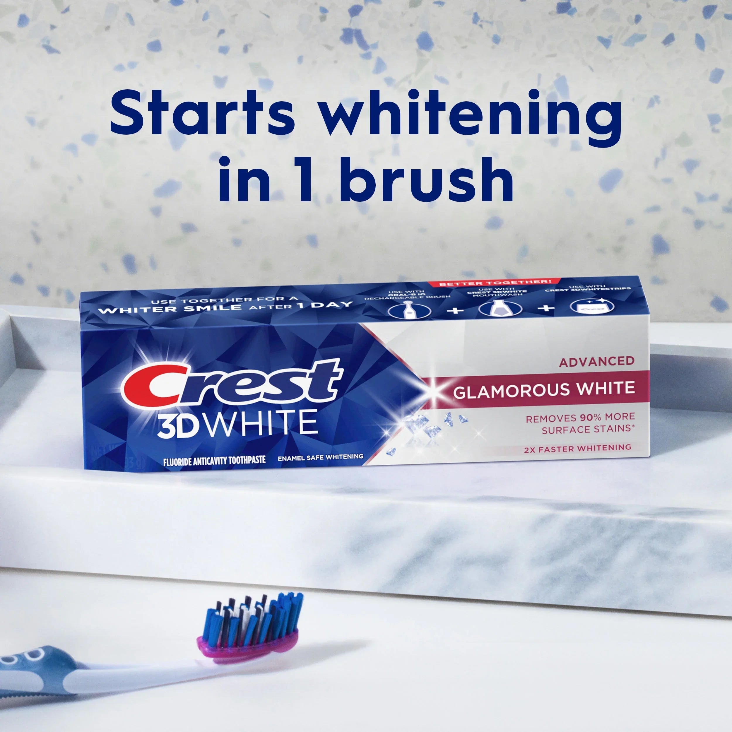Crest 3D White toothpaste tube with a toothbrush on a speckled background
